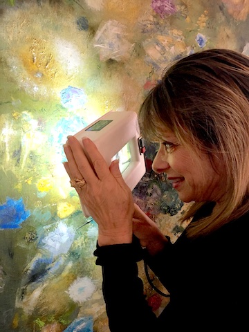 Kathy inspecting a piece of art